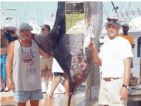 Picture of a large fish hanging, with two guys standing next to it