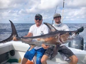 Picture of two guy's catch of a marlin fish. Part of a home page slide show.